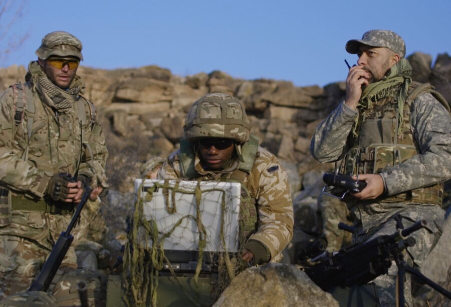 Military communications power needs - 3 men in uniform on coms